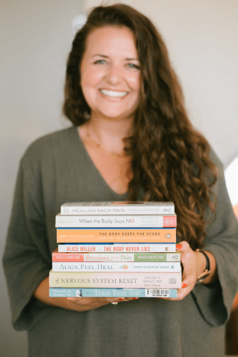 Melanie Goetz Holding Books Upward Roots Relational Therapy