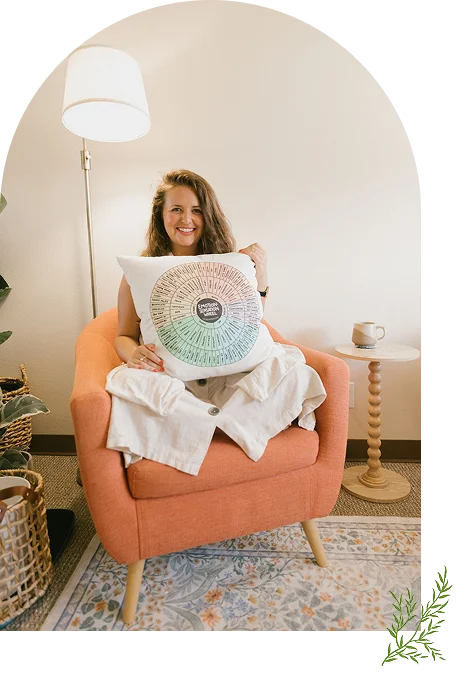 Melanie Goetz Relational Therapist Holding Feelings Wheel Pillow